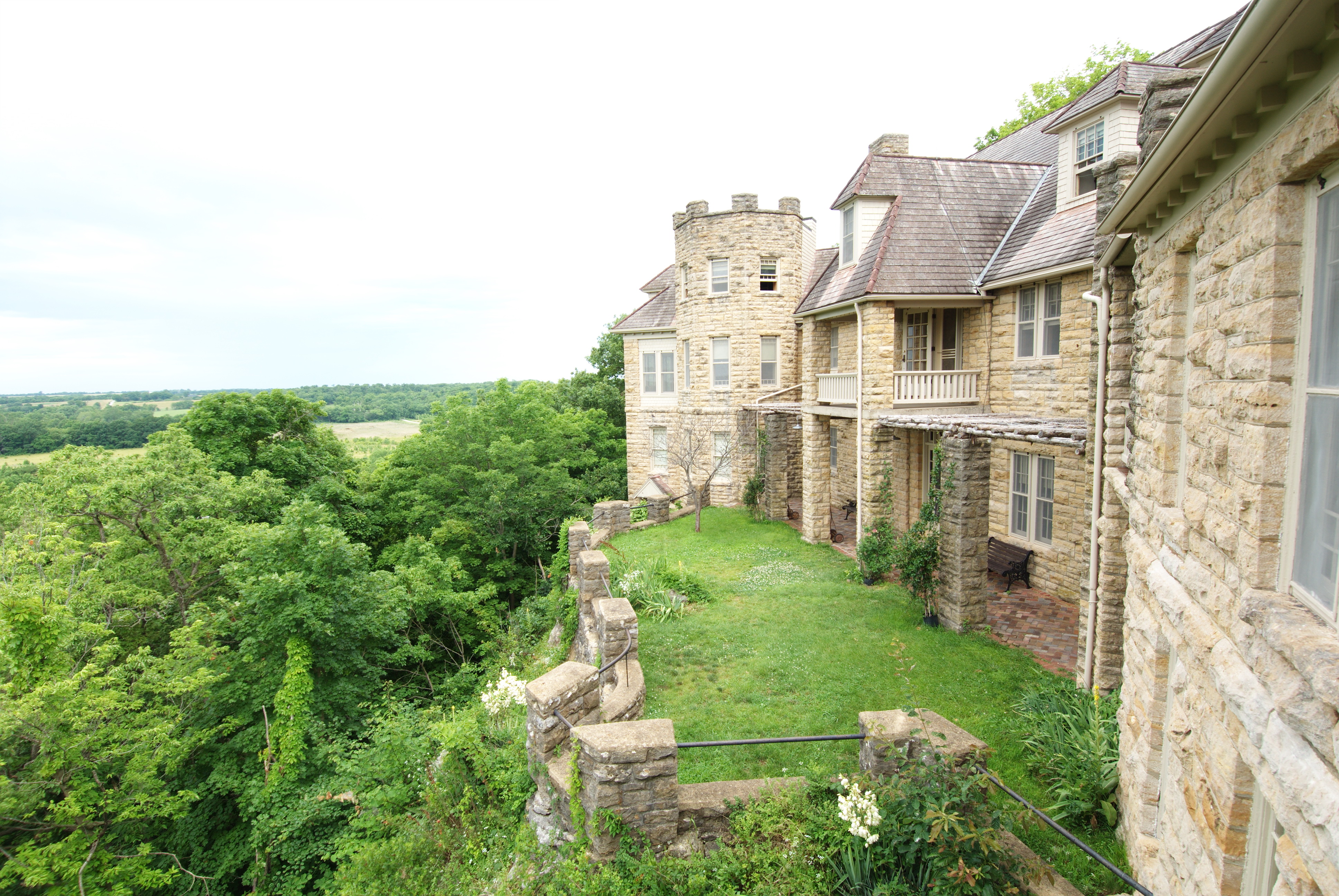 view of huge rock lodge on bluff overlooking fields