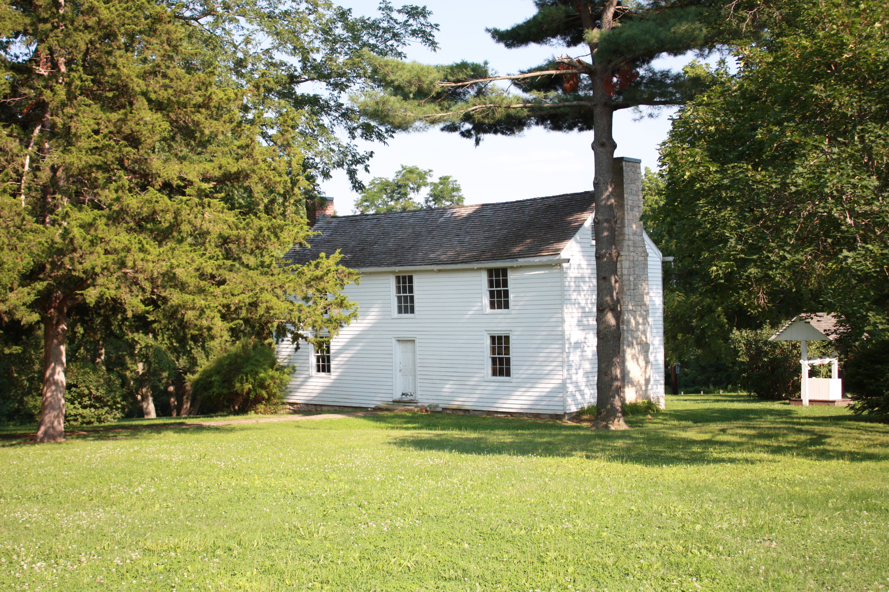 old two-story white boarding house