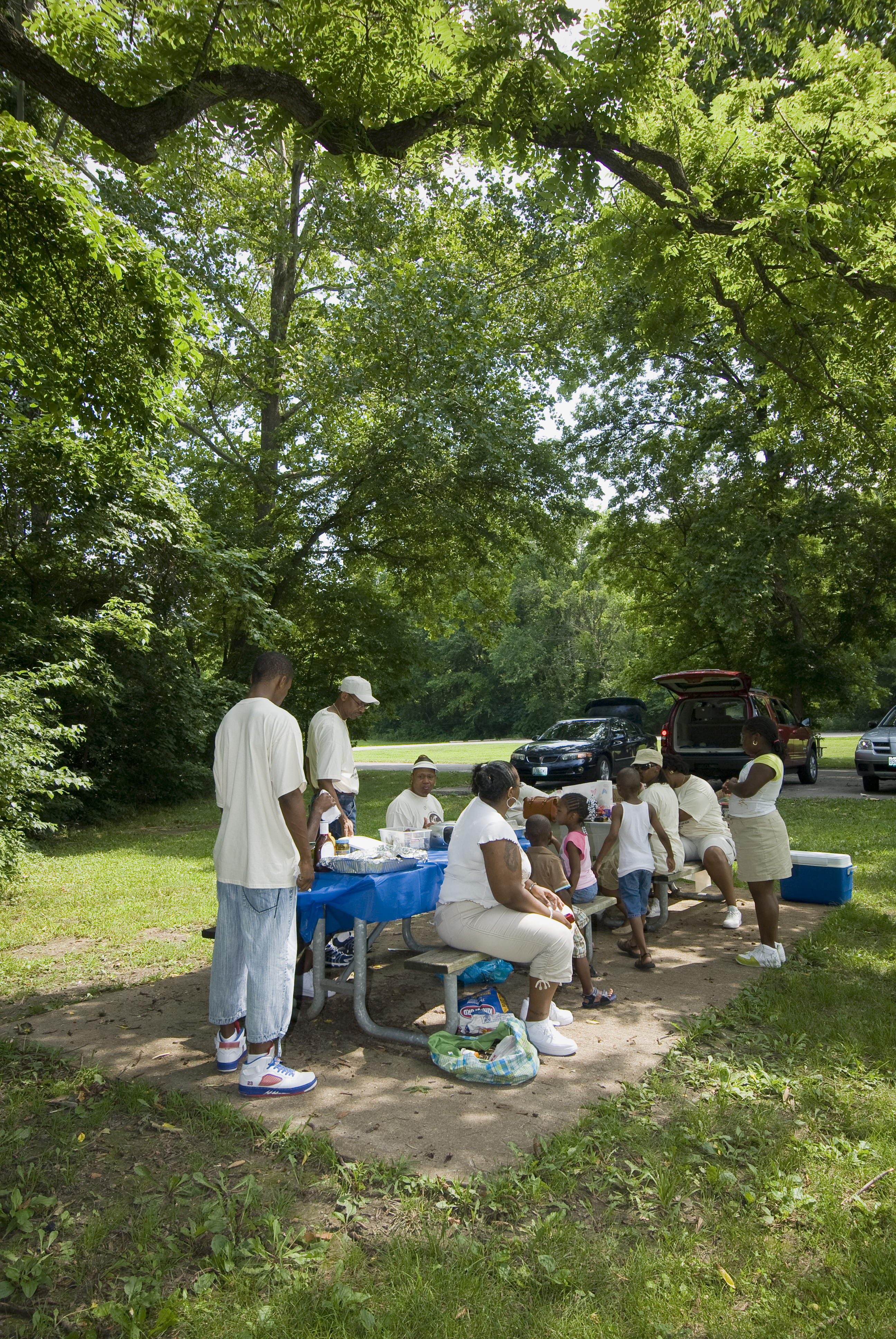 large group gathered at a picnic table enjoying lunch