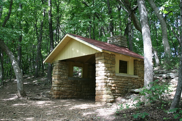 small rock building with roof and open on one side