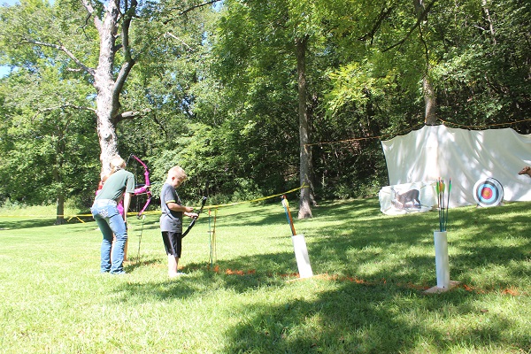 two people practicing archery