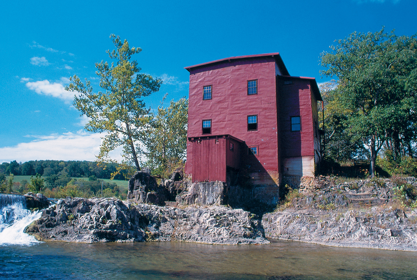 water cascading over a ledge near the red mill