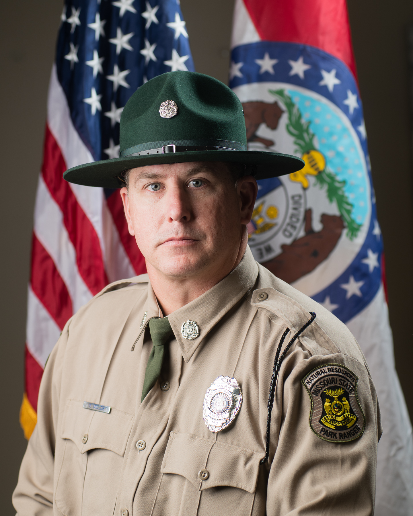 David Miller in hat and uniform with U.S. and Missouri flags and background