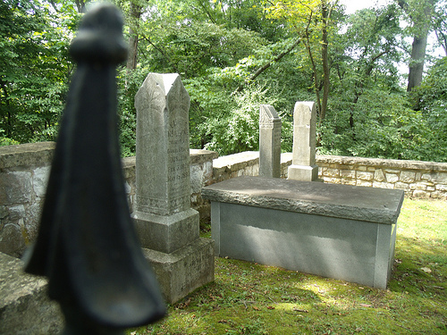 tombstones in the small cemetery surrounded by a rock wall