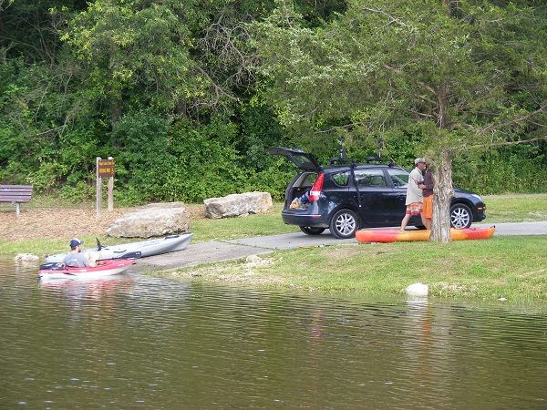 people launching kayaks at the boat ramp