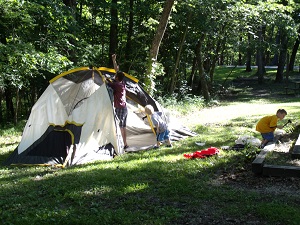 kids playing by tent in campground