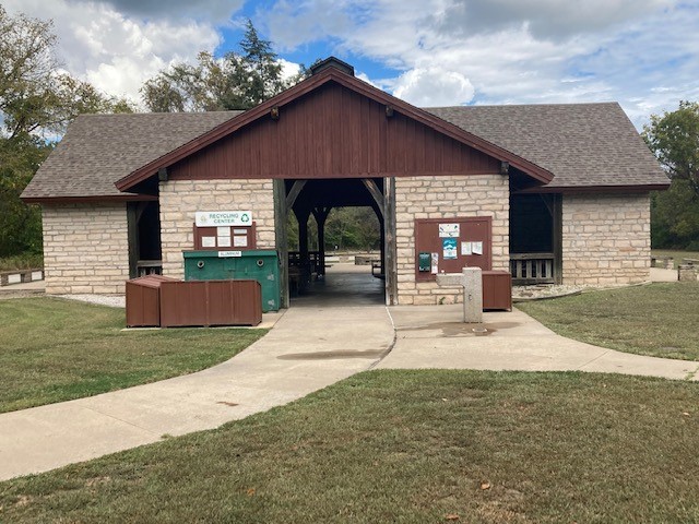 Front of the shelter, along with trash and recycling bins, and a water fountain