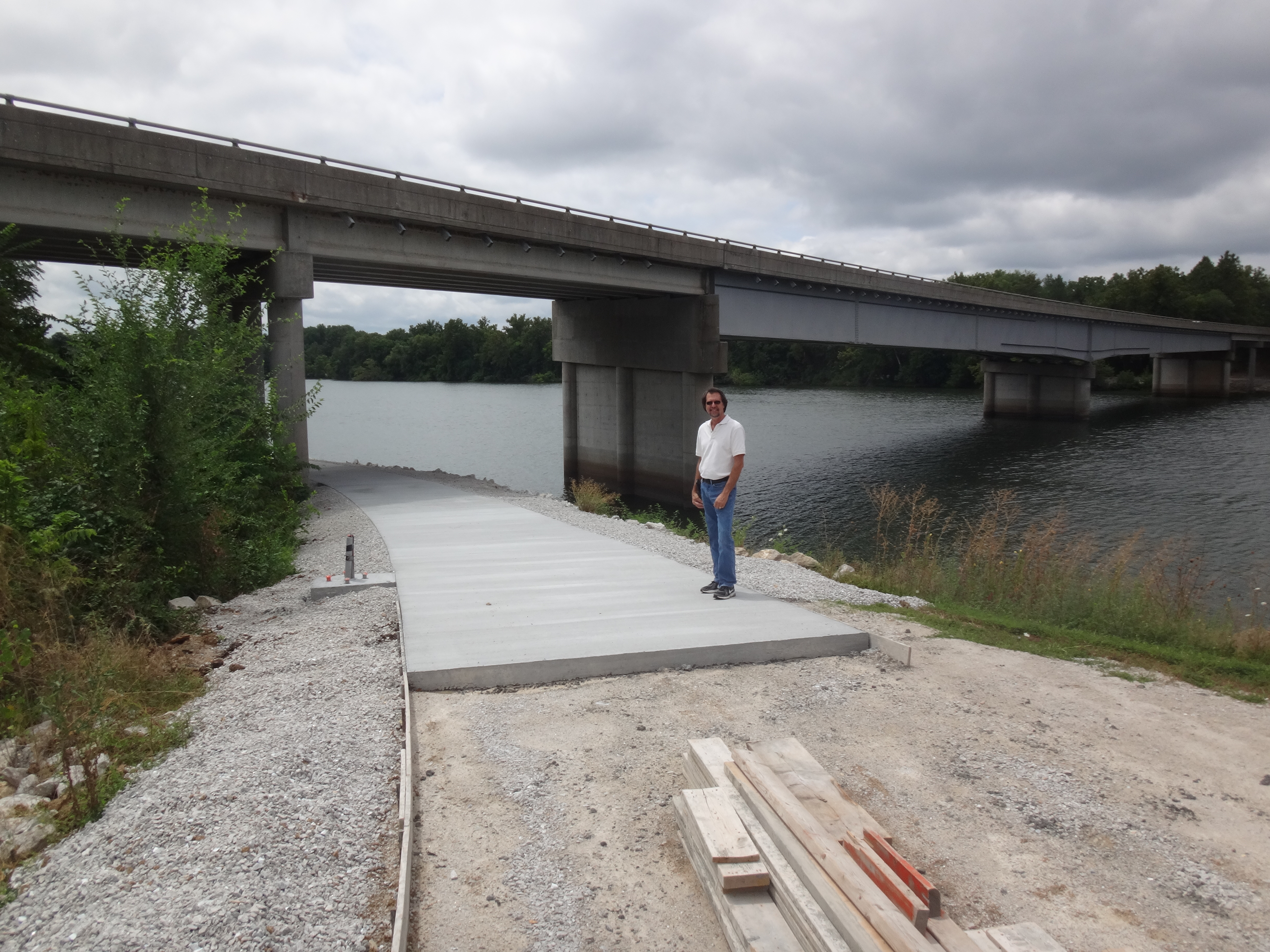 a man standing on a trail that is being constructed