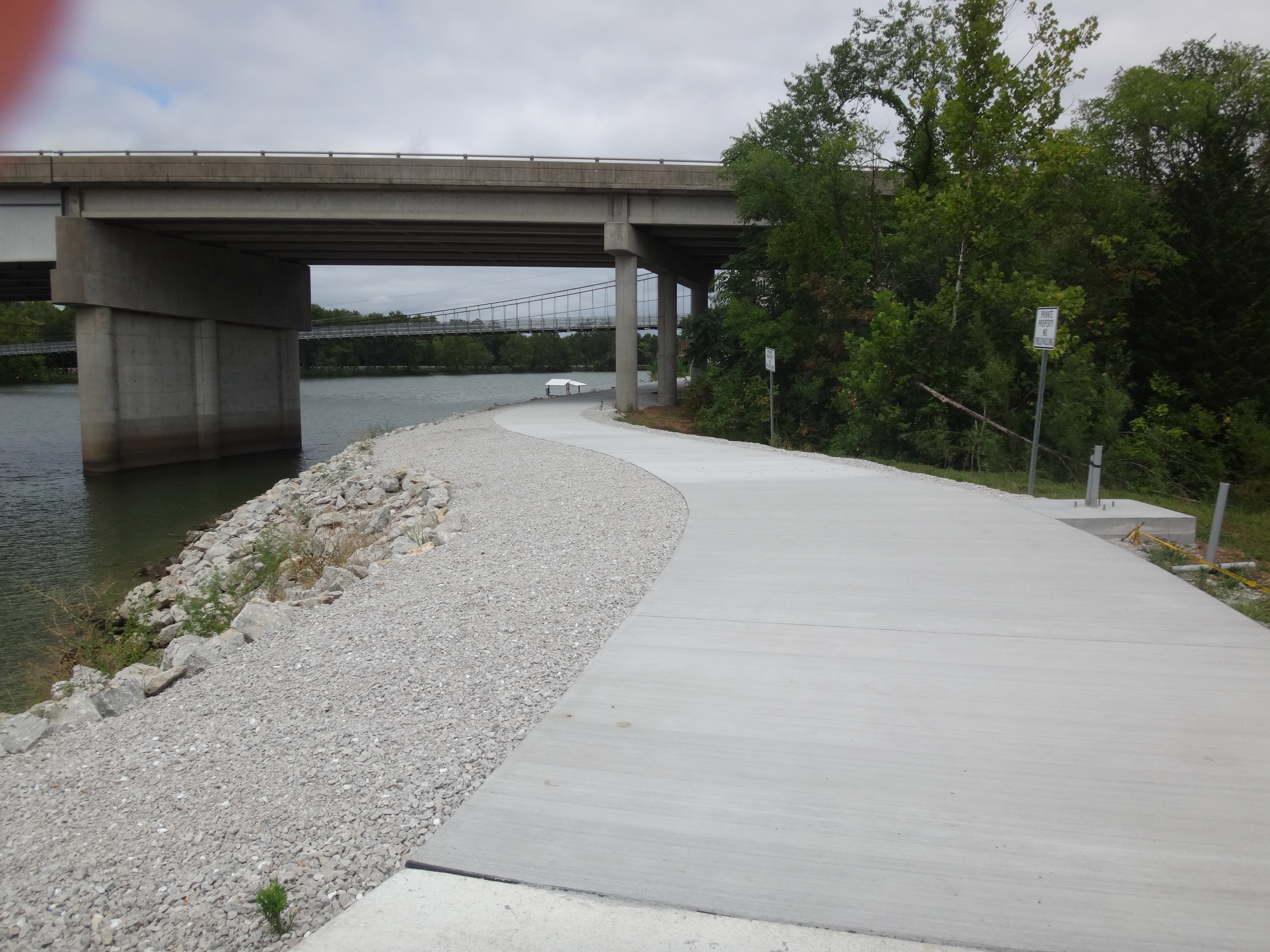 a concrete trail going under an overpass