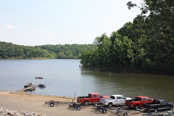 trucks with boat trailors parked next to the boat ramp