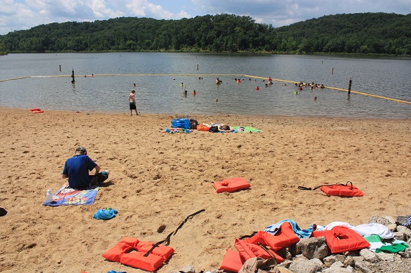 people on swimming beach and in the lake swimming