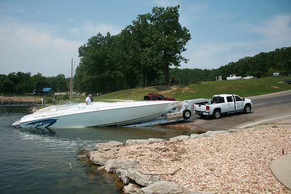 someone launching a boat on the paved ramp