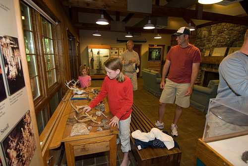 a young girl looking at the exhibits inside the visitor center