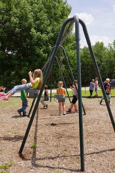 kids playing on the swing set