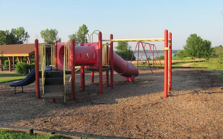 playground equipment with monkey bars, slides and a swing set