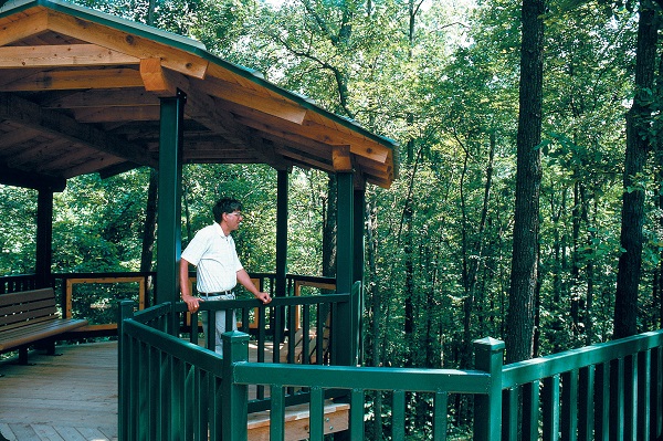 a man standing on the overlook enjoying the view