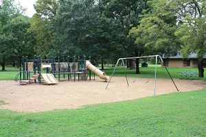 playground equipment with multiple slides and a swing set