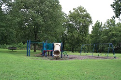 playground equipment with slides and a swing set
