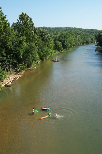 aerial picture of people swimming with rafts and tubes