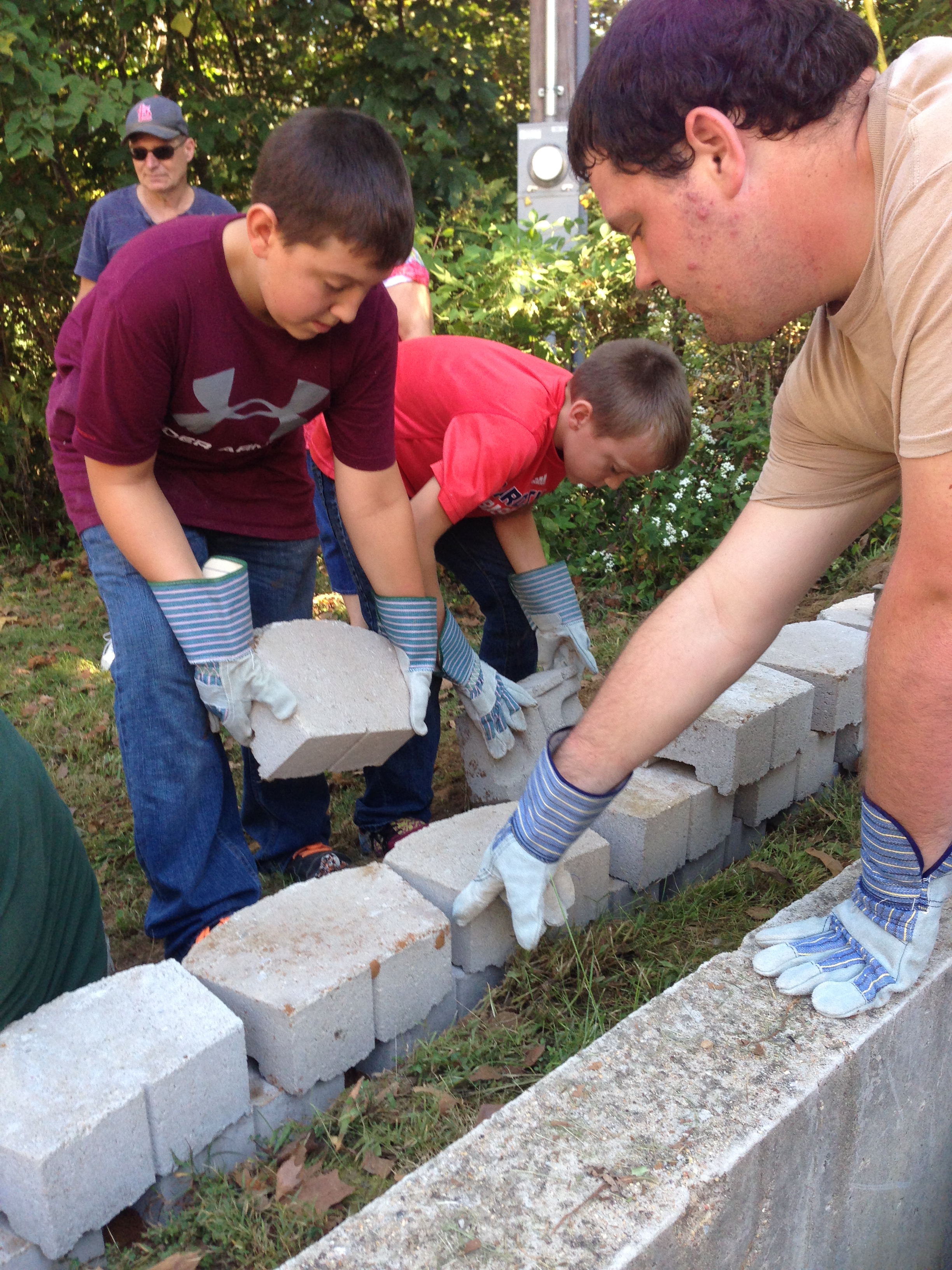 boys working to build a rock wall