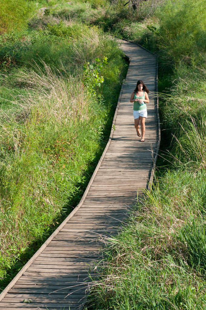 a woman walking on the boardwalk