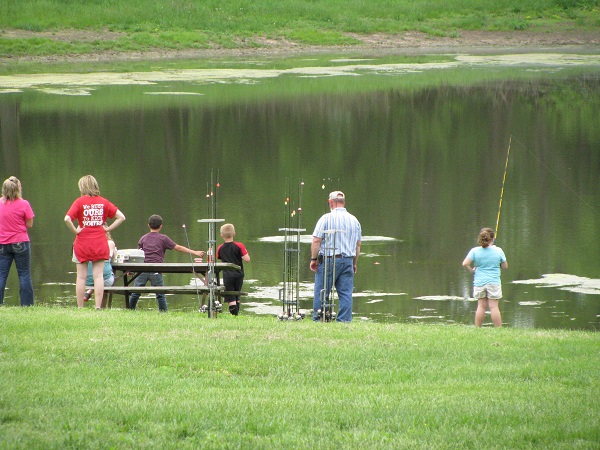 people fishing off the lake shore