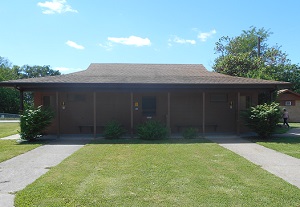 exterior of showerhouse with two sidewalks leading to it