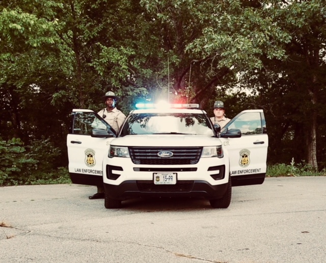 two rangers posing by their ranger vehicle