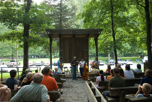 people sitting in the amphiteater watching a program