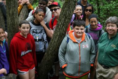 a group of kids posing for a picture with the park naturalist