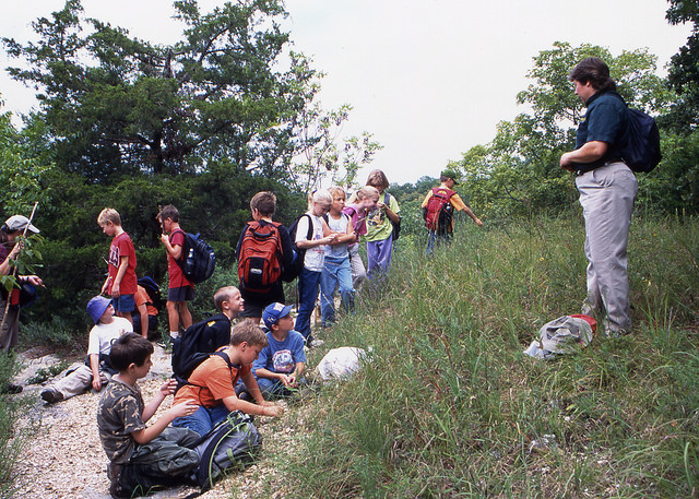 a group of kids on a guided hike with the naturalist