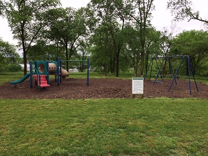 playground equipment with slides and a swing set