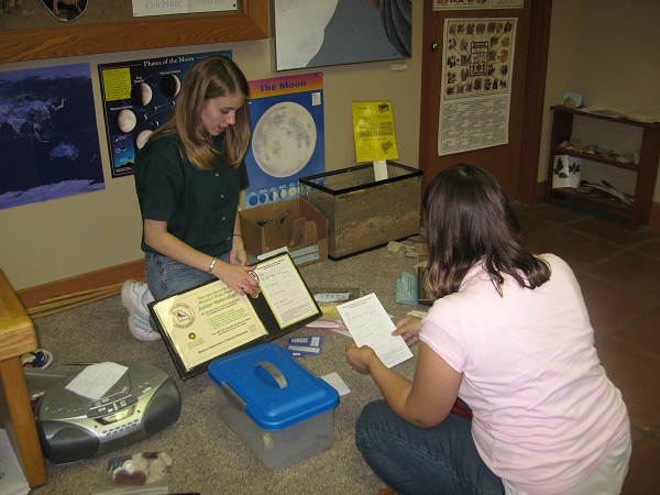 two women looking at a display