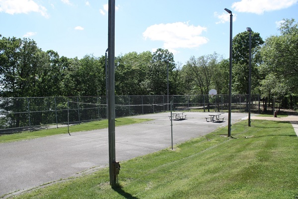 paved play court with volleyball net