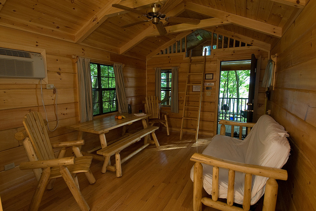 futon and table with bench inside a camper cabin