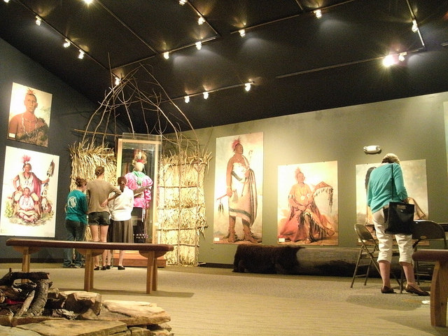 people looking at displays relating to Native Americans inside the visitor center
