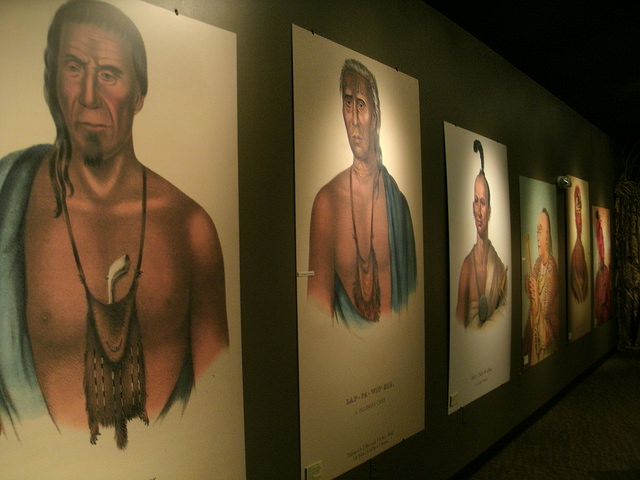 prints of paintings of Native Americans hanging in the visitor center