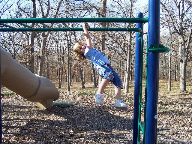 a girl on the monkey bars