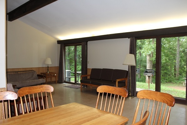 table and chairs, futon and patio doors inside the cabin