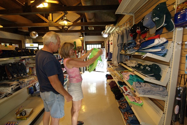 a couple looking at t-shirts inside the store