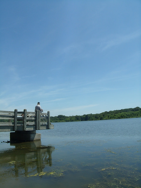 a guy fishing off of the fishing dock