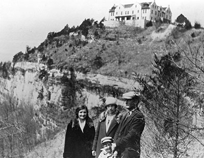 Historic photo of a family standing below the bluff where the Ha Ha Tonka castle is