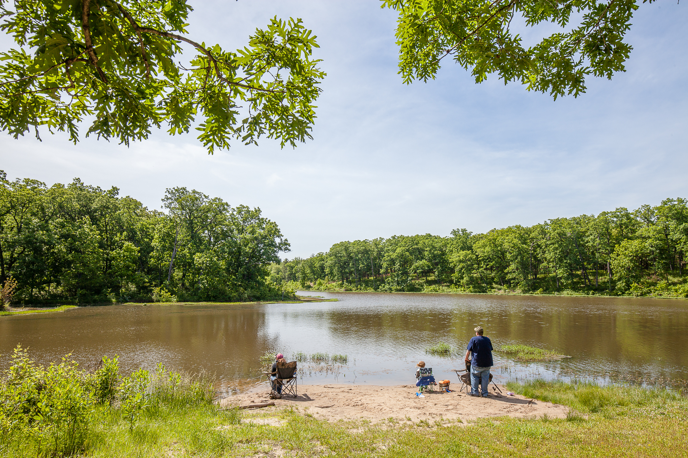 People sitting on the edge of a river