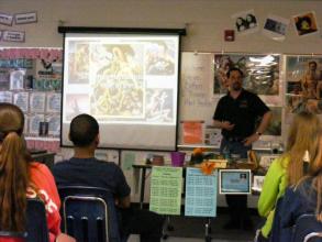 staff present a PowerPoint presentation at a school