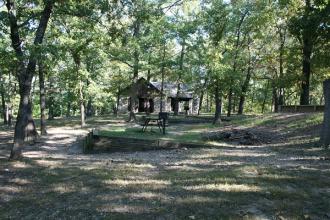 shelter and picnic tables in shaded area