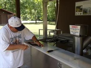 man cleans a fish at the fish cleaning station