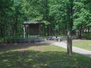 sidewalk leads to wooden benches and stage of amphitheater