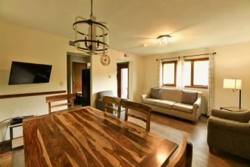 Dining table and living room area of lodging unit.