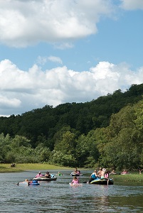 several canoes, kayaks and rafts floating on the river