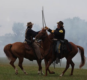 Battle re-enactors on horses fighting with swords